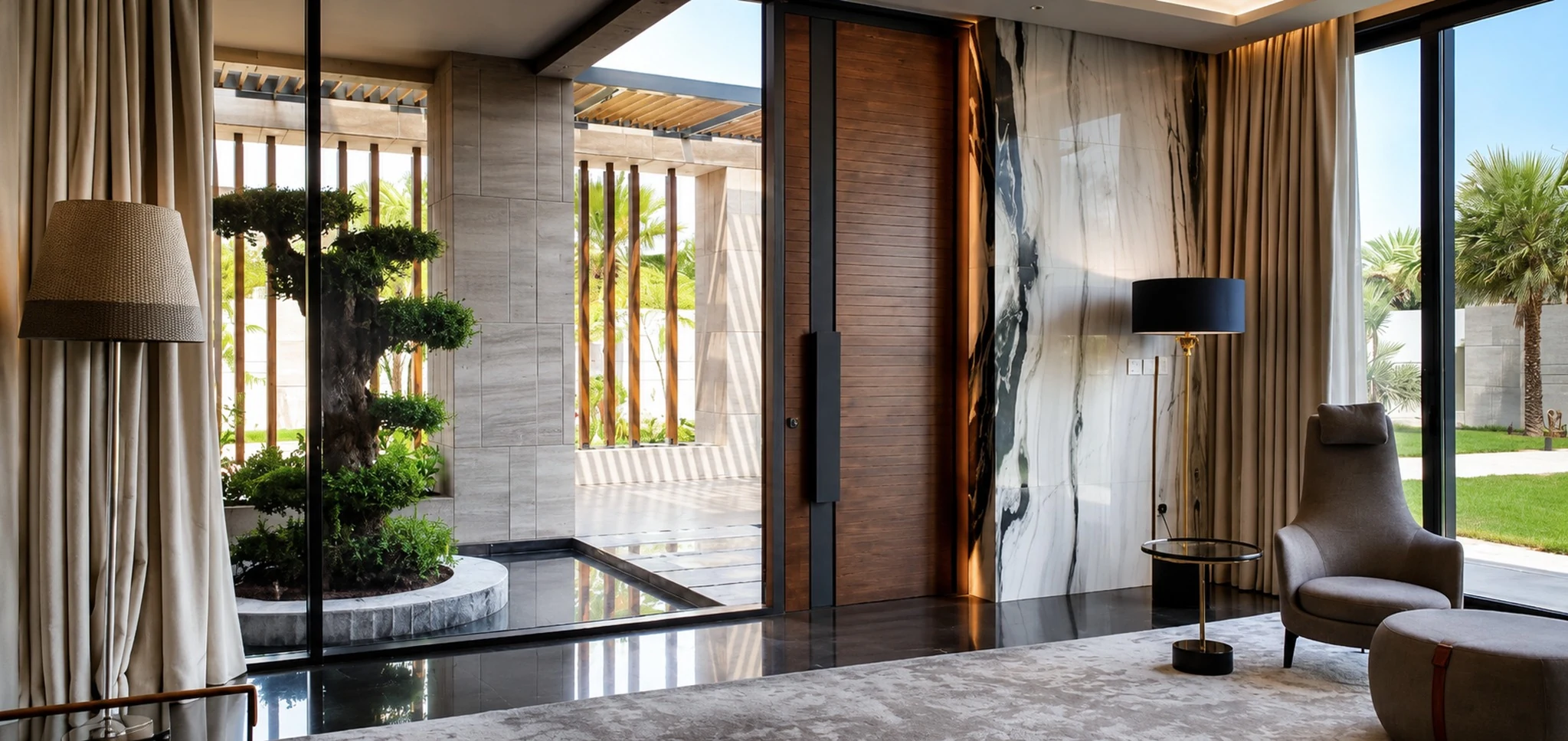 Entry, bonsai court and marble pivot door — villa interior in Dubai by Soltis Interiors
