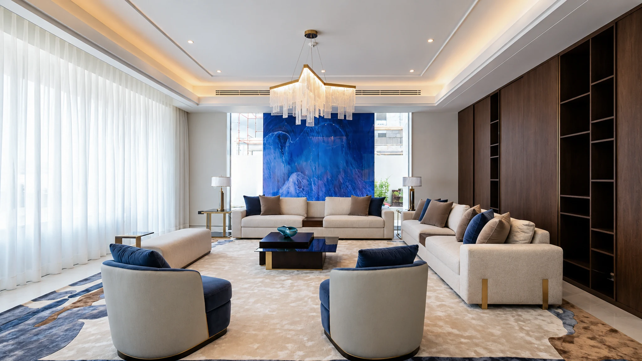 Living, blue art and tassel chandelier — mansion interior in Dubai by Soltis Interiors